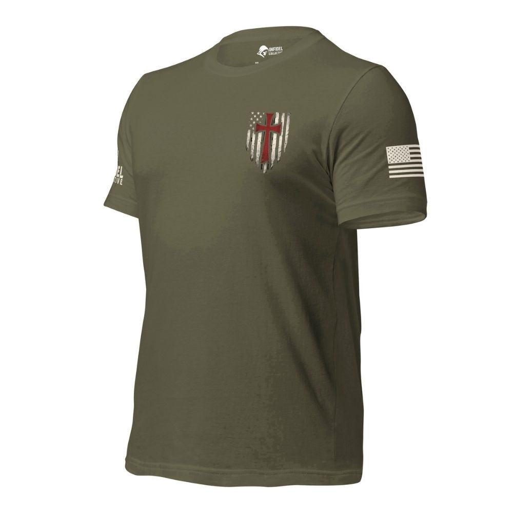 Front-left view of the Military Green Crimson Cross tee with chest graphic, U.S. flag sleeve detail, and Infidel Collective sleeve branding.
