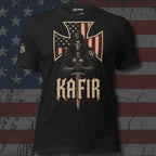 A black short-sleeve graphic t-shirt featuring a grim reaper design with an American flag cross, a sword, and the word 'KAFIR' in a gothic font. The shirt is displayed against a distressed American flag background.