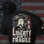 Black tee with back print featuring a skull under the Liberty Bell, a rattlesnake, distressed American flag graphic, and the text Liberty Ain't Fragile