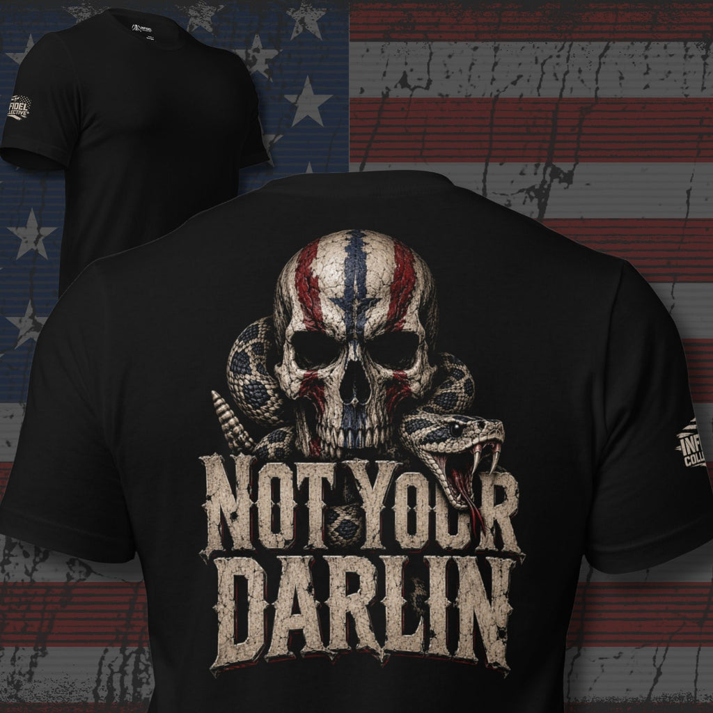 Not Your Darling back print graphic on black tee featuring a distressed skull with American flag markings and a coiled rattlesnake