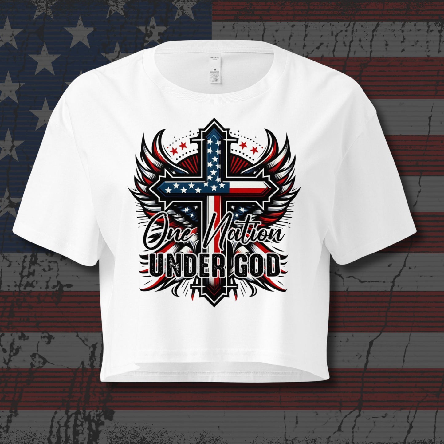 White t-shirt with a patriotic design featuring a cross and 'One Nation Under God' text on an American flag background.