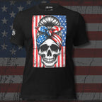 Patriotic skull bandana front print tee with skull wearing American flag head wrap in front of distressed American flag on black shirt
