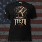 Black tee with front print featuring a snake skull with American flag pattern and the text Raised With Teeth