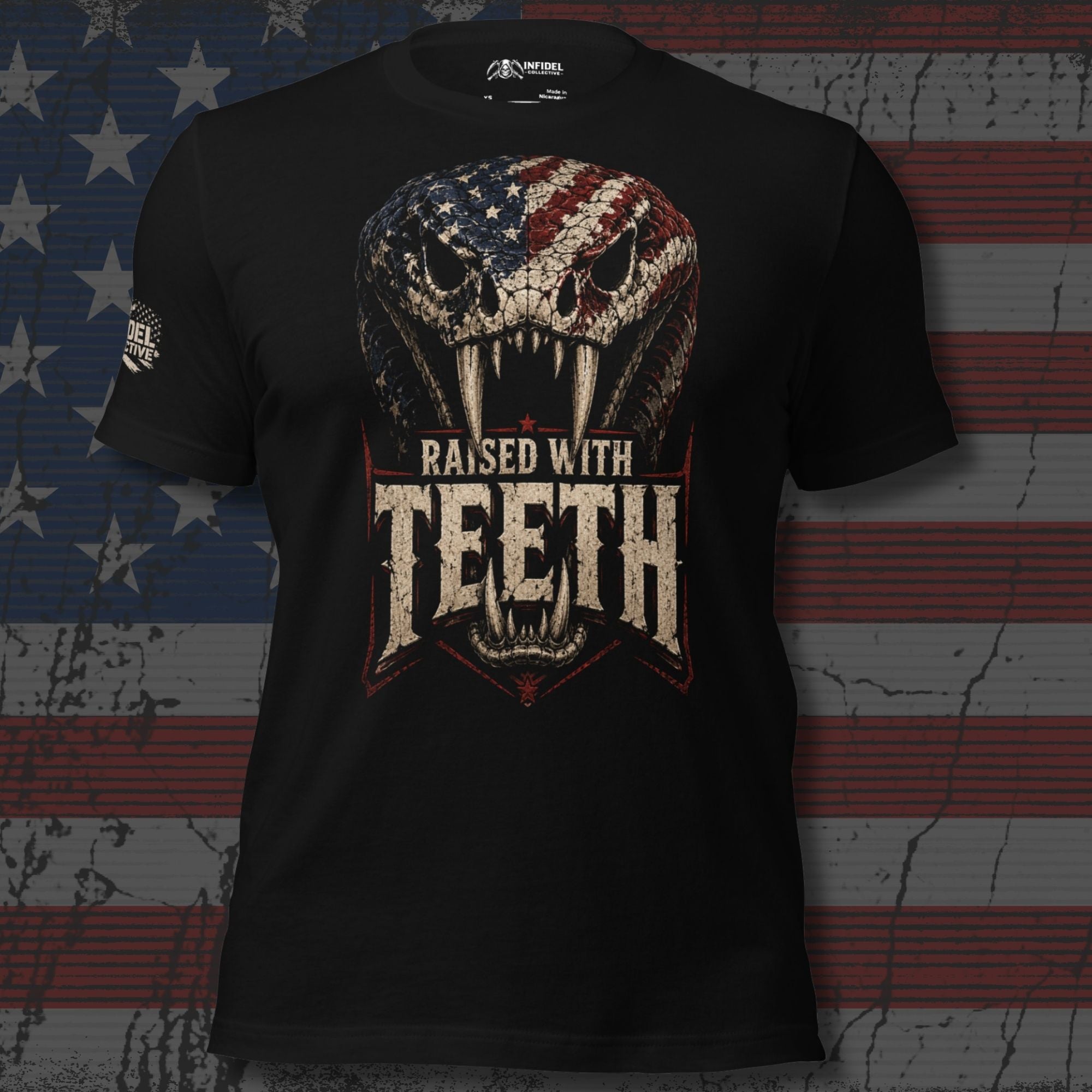 Black tee with front print featuring a snake skull with American flag pattern and the text Raised With Teeth