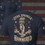 Red White and Booze Hammered back print graphic on navy tee featuring a hand holding the Statue of Liberty torch with patriotic stars and vintage lettering
