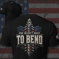 She Wasn't Built to Bend Liberty torch and flag shield back print black tee from Infidel Collective