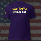 Purple t-shirt with 'SHITSHOW SUPERVISOR' text on a textured flag background