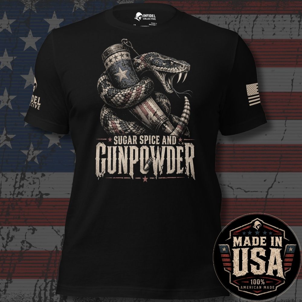 A black short-sleeve graphic T-shirt displayed against a distressed American flag background. The shirt features a large front print of a coiled snake wrapped around a patriotic American flag cylinder, with the text 'SUGAR SPICE AND GUNPOWDER' below. Brand logo INFIDEL COLLECTIVE on right sleeve and USA American flag on left. Made In The USA badge in lower right corner.