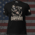 A front view of black short-sleeve t-shirt with a graphic print of a coiled snake holding a revolver and a star-patterned mug, with the text 'SUGAR SPICE AND GUNPOWDER' on the front. The brand name 'INFIDEL COLLECTIVE' is visible on the right sleeve with USA American flag on the right sleeve, against a distressed American flag background.