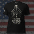 The Road Knows Its Own hooded reaper front print black tee from Infidel Collective