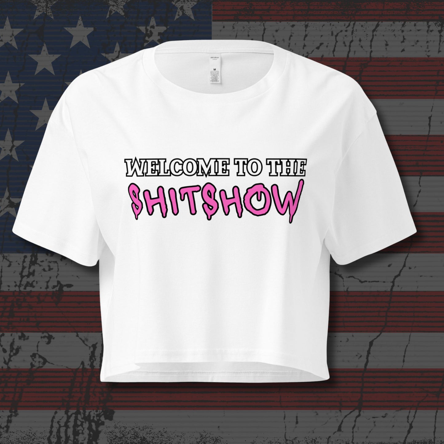 White crop top with white and pink text that says "Welcome to the Shitshow" on distressed American Flag