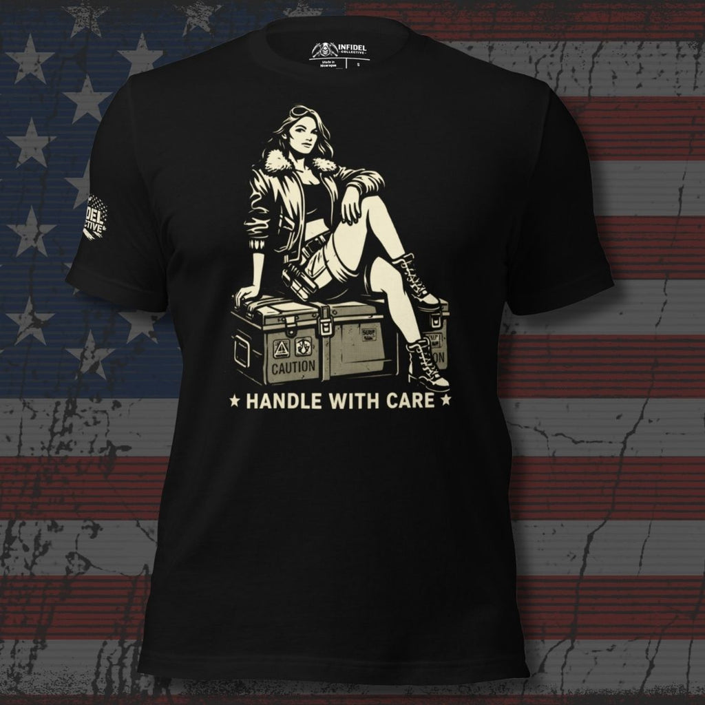 Black t-shirt with graphic design of a woman sitting on a suitcase and text 'HANDLE WITH CARE' against an American flag background.