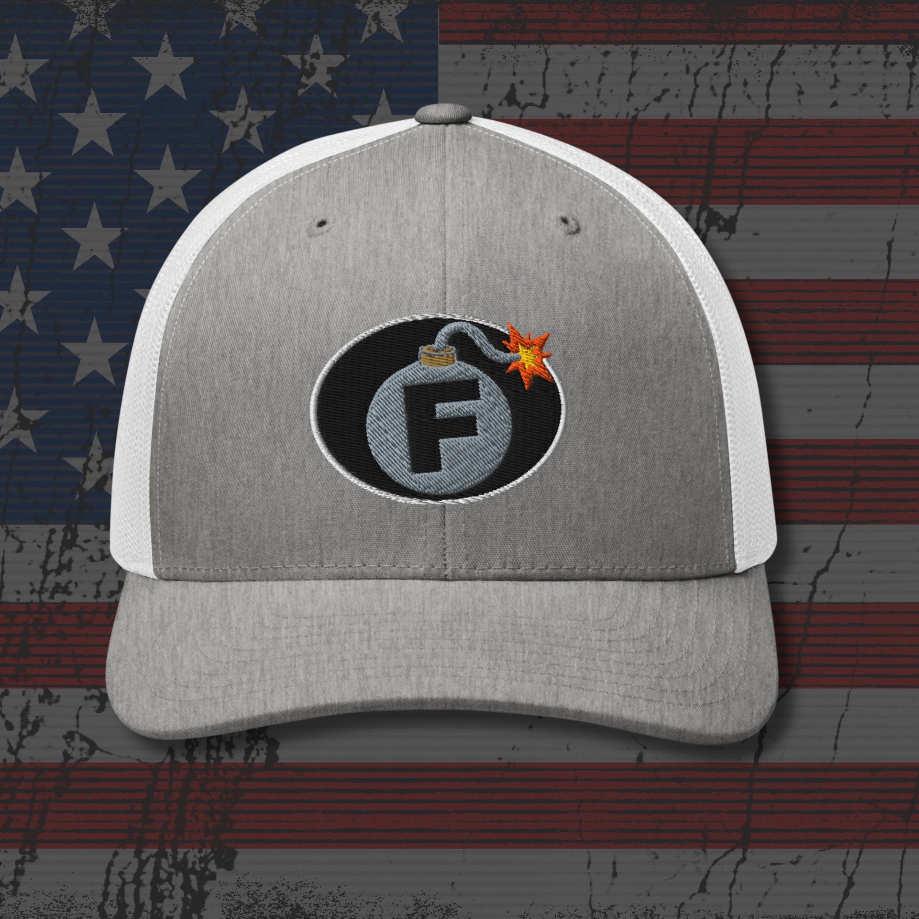 Gray and white cap with a bomb-themed logo on an American flag background
