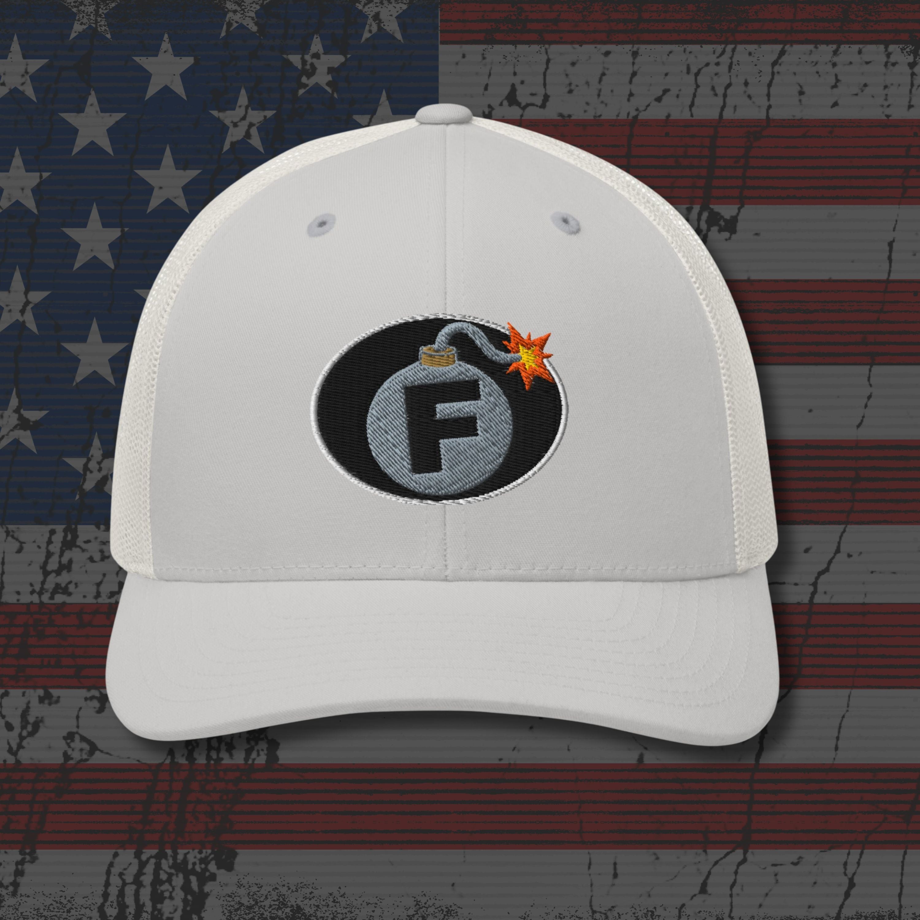 White cap with a bomb graphic featuring the letter 'F' on an American flag background