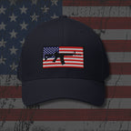 Navy blue cap with American flag and gun emblem on a distressed American flag background