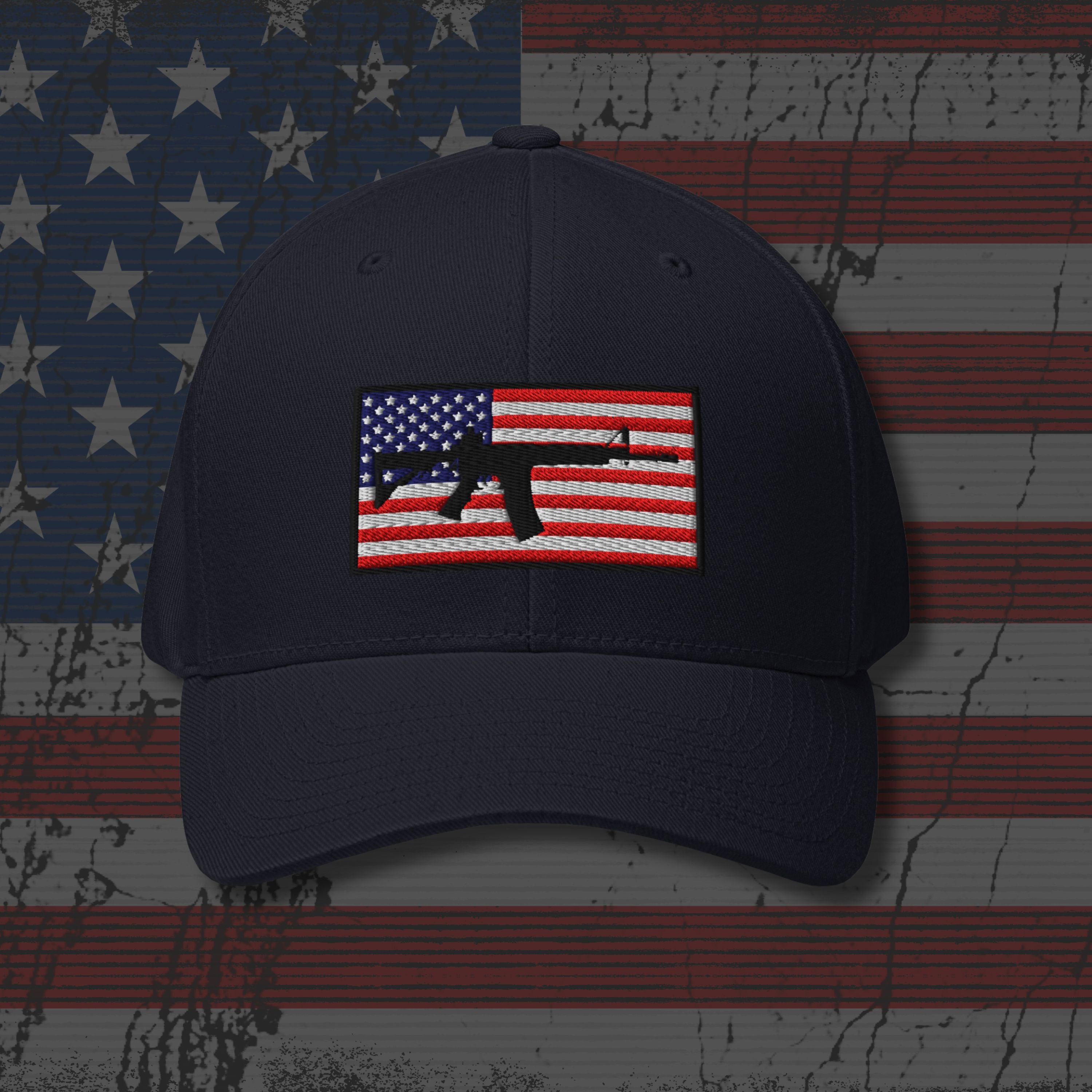 Navy blue cap with American flag and gun emblem on a distressed American flag background