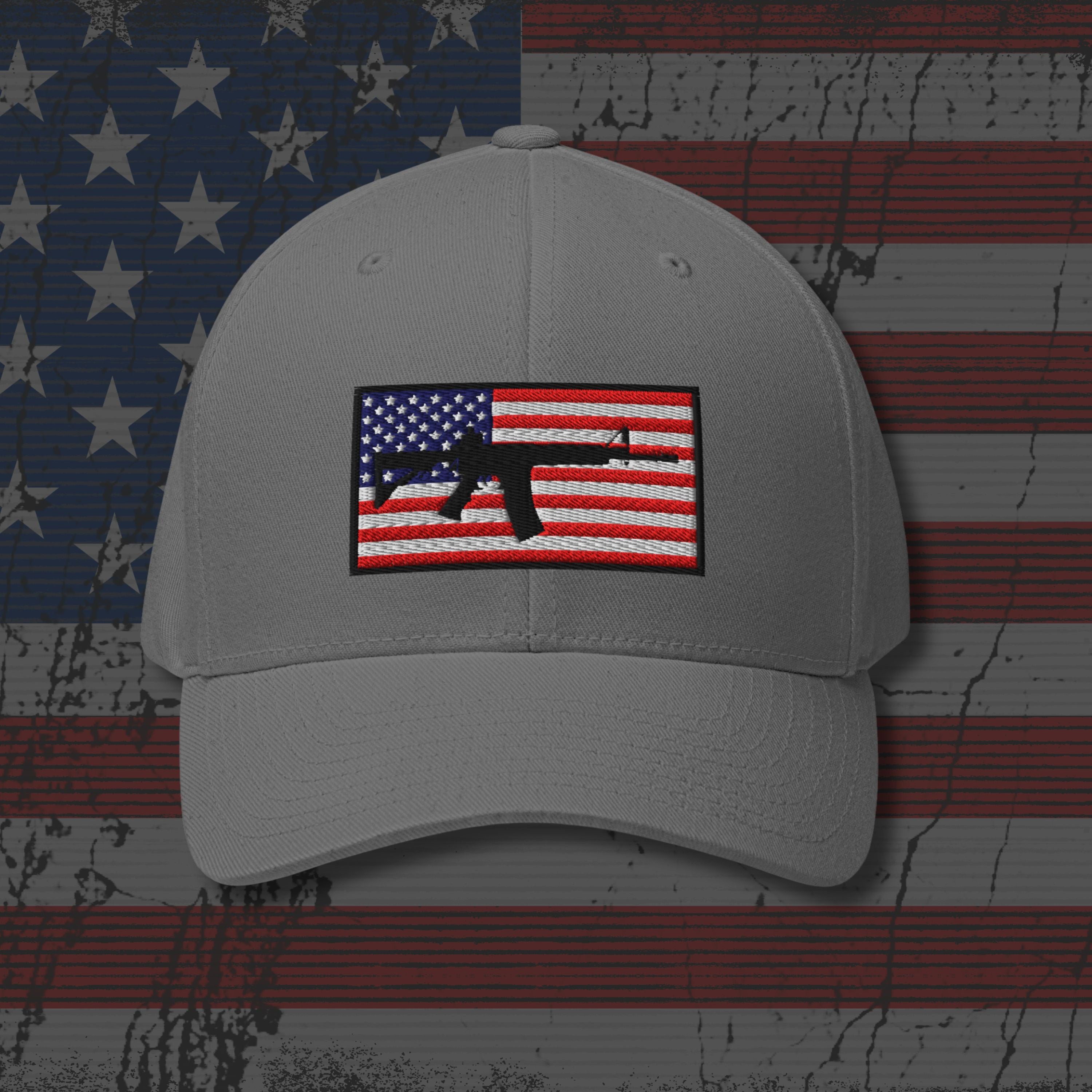 Gray cap with American flag and gun emblem on a distressed American flag background