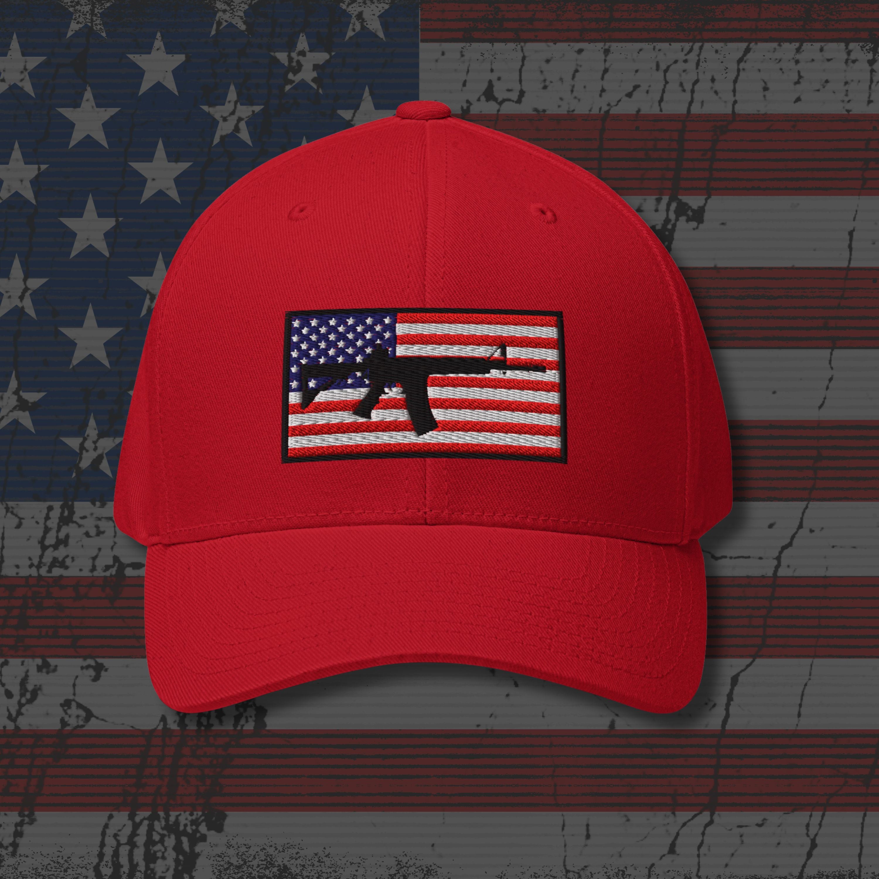 Red cap with an American flag and gun emblem on a distressed American flag background