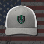 Gray and white cap with a skull emblem on an American flag background