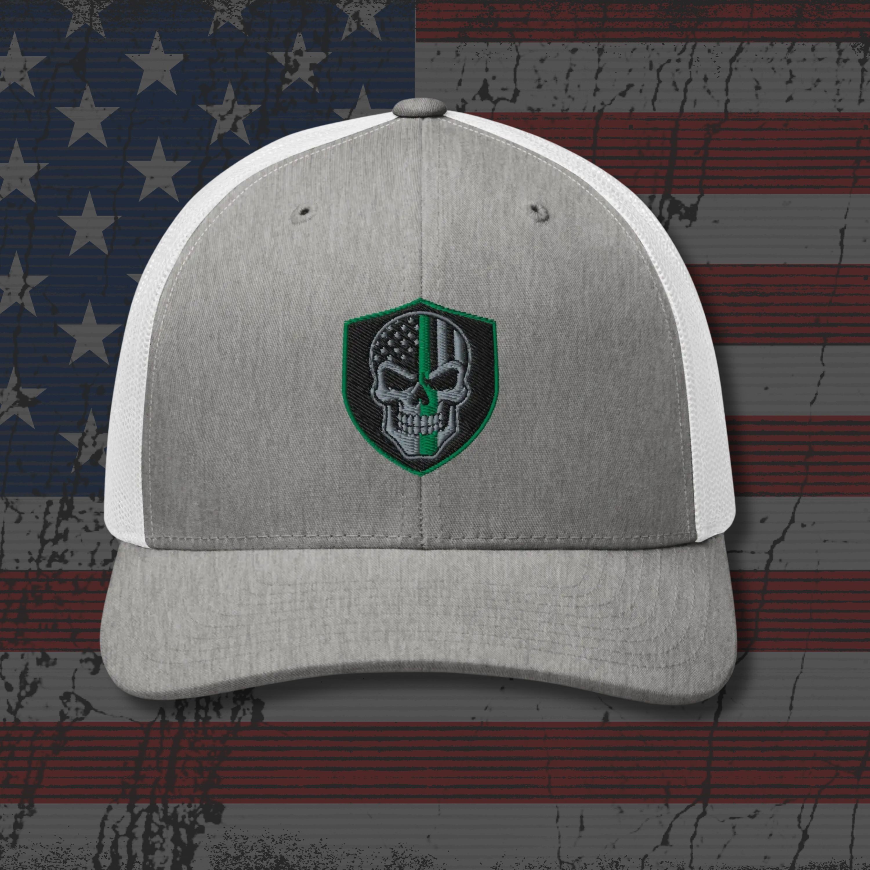Gray and white cap with a skull emblem on an American flag background