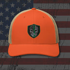 Orange and beige cap with a skull emblem on an American flag background
