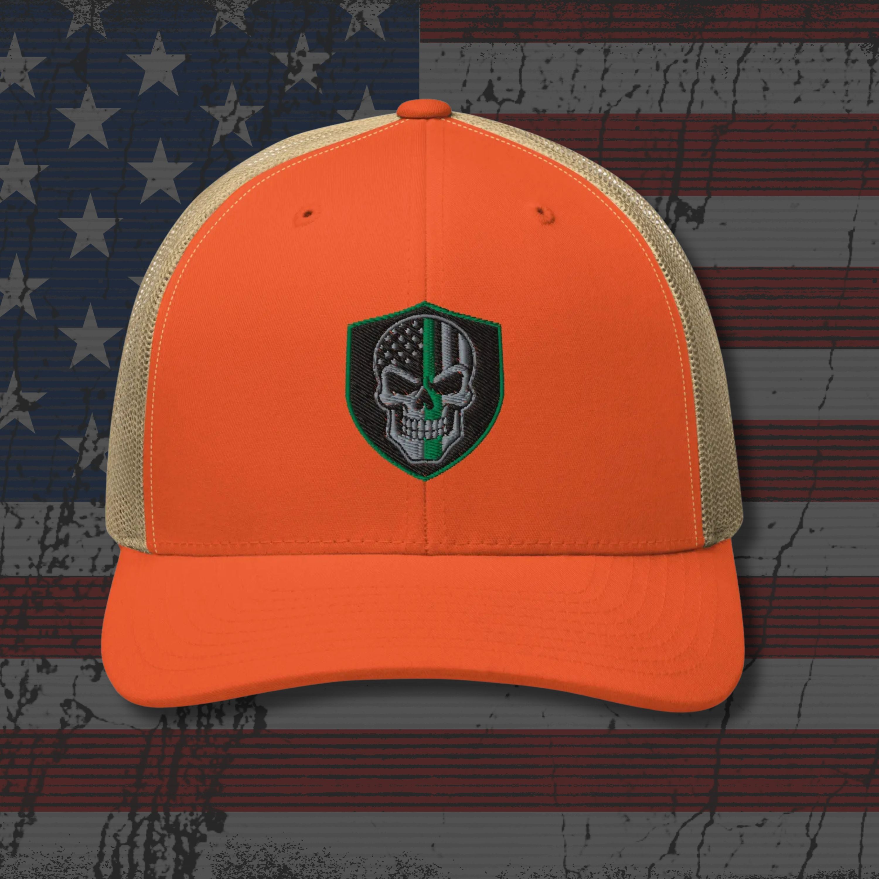 Orange and beige cap with a skull emblem on an American flag background