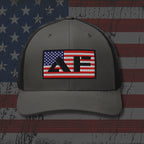 Gray cap with American flag logo on a distressed American flag background
