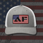 Gray and white cap with a logo on an American flag background