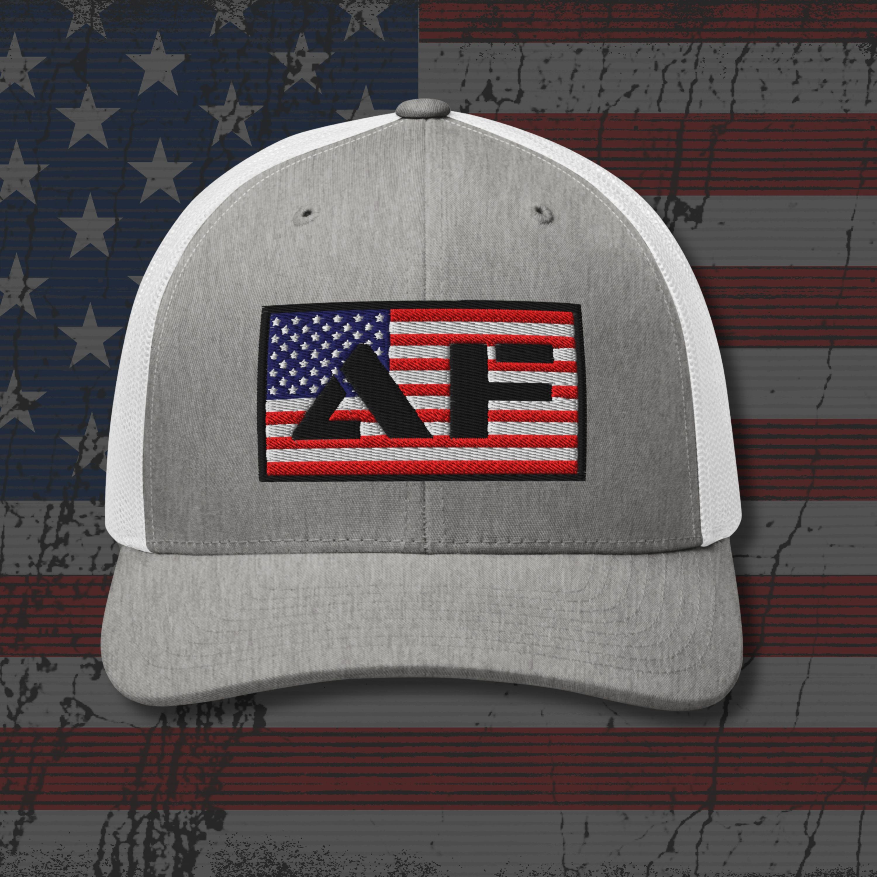 Gray and white cap with a logo on an American flag background