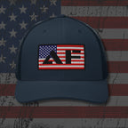 Navy blue cap with a red, white, and blue logo on an American flag background