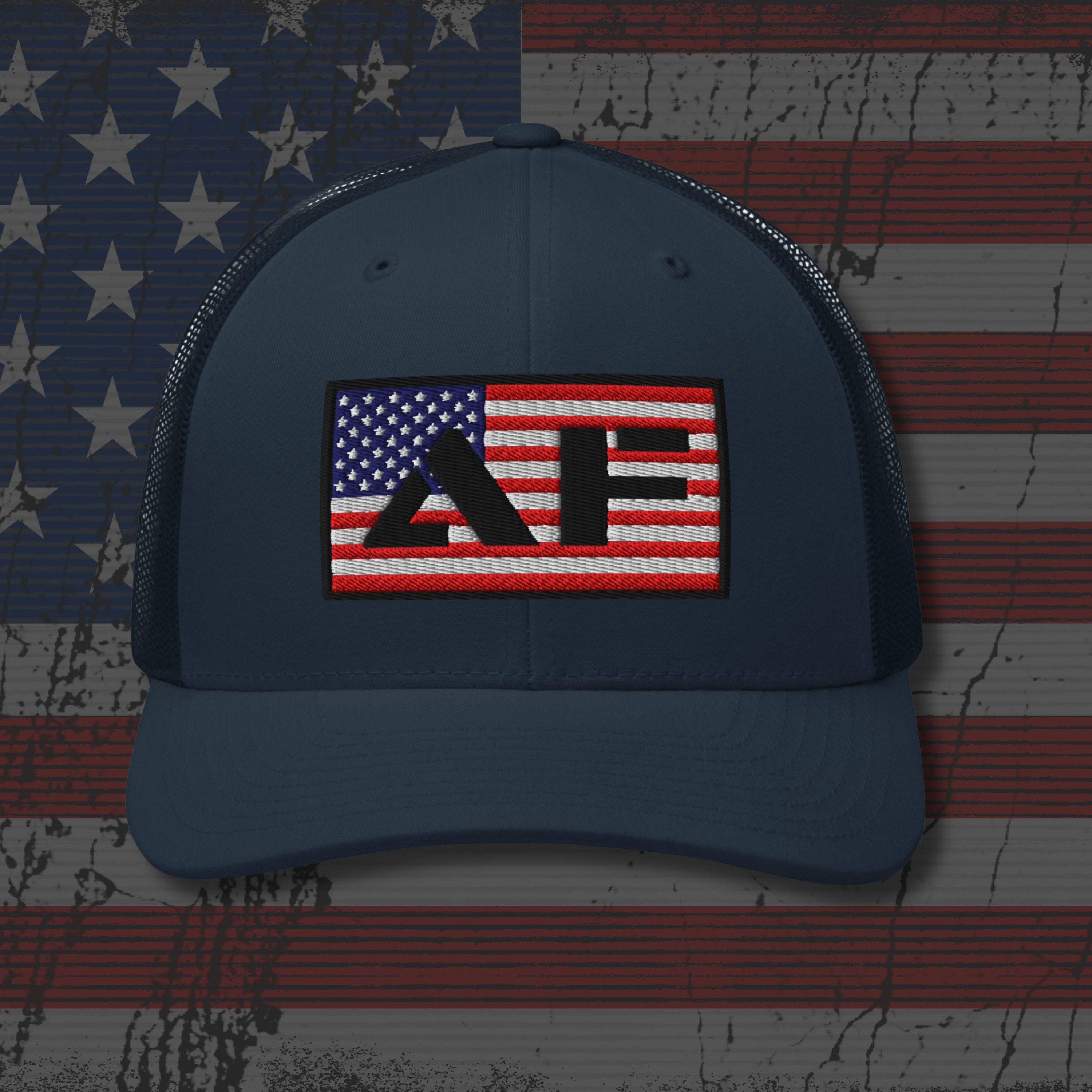 Navy blue cap with a red, white, and blue logo on an American flag background