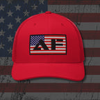 Red cap with a logo on an American flag background