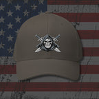 Brown cap with skull and crossed swords emblem on an American flag background