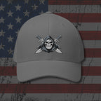 Gray cap with skull and crossed swords emblem on an American flag background