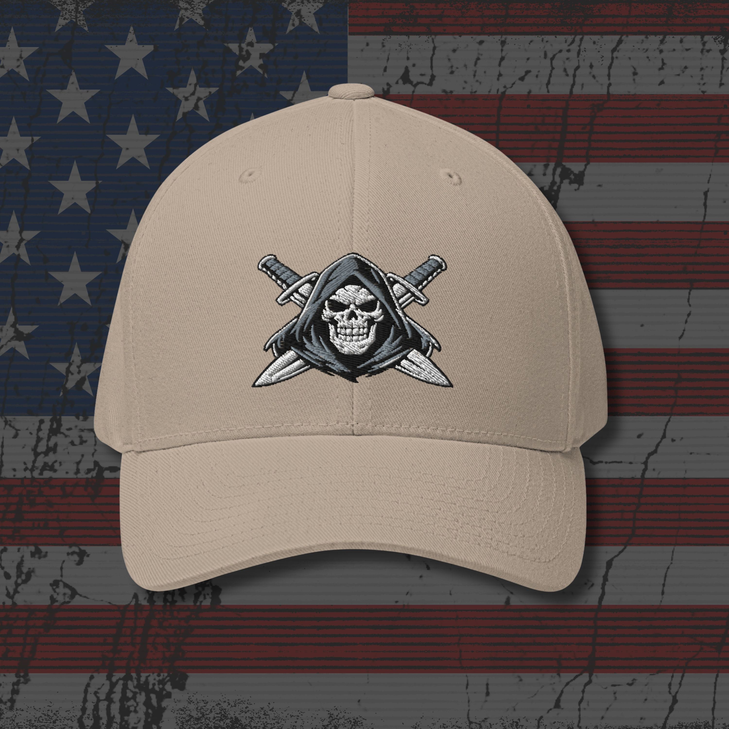 Beige cap with skull and crossed swords emblem on an American flag background