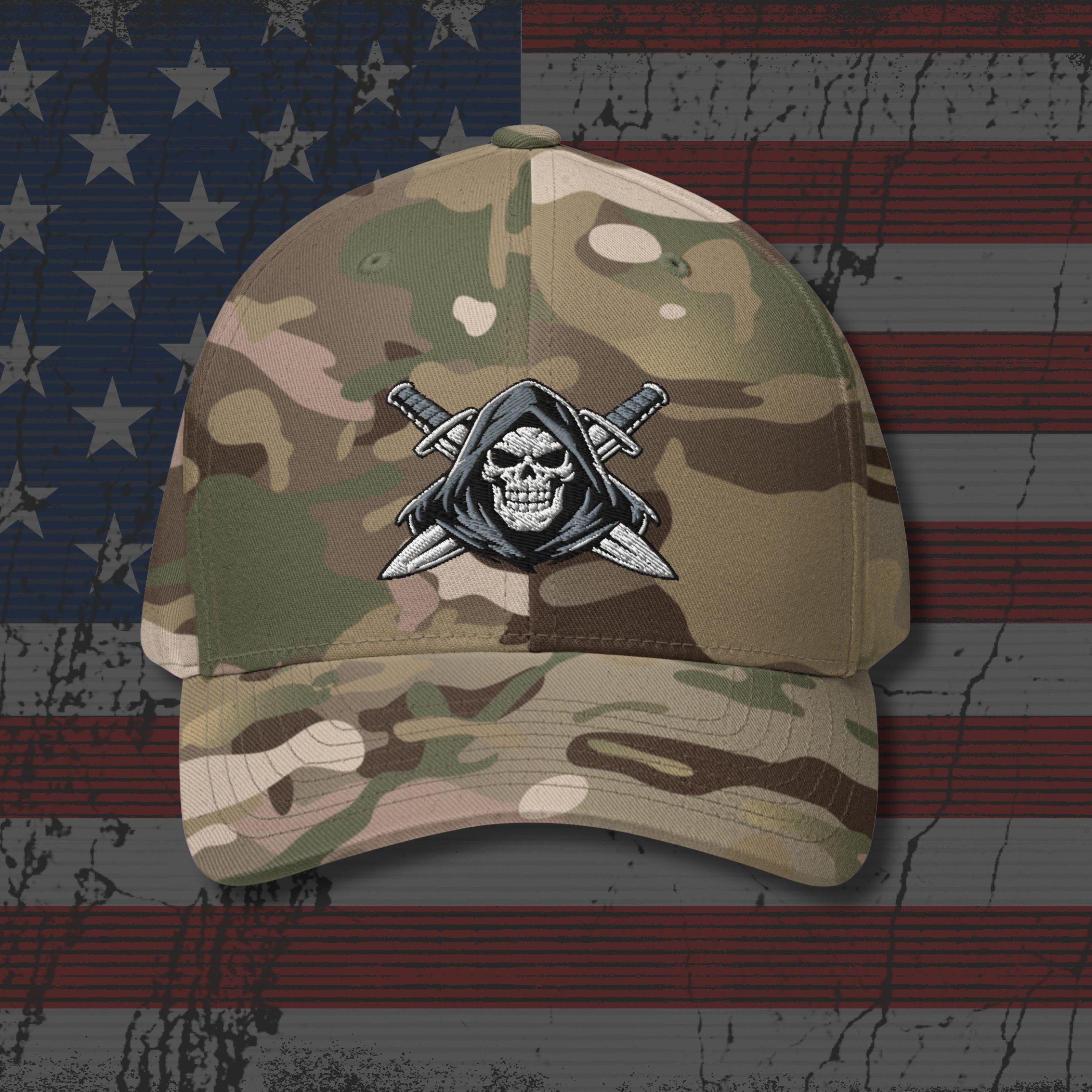 Camouflage baseball cap with skull and sword emblem on an American flag background