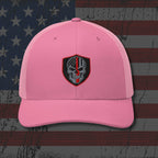 Pink cap with a skull emblem on an American flag background