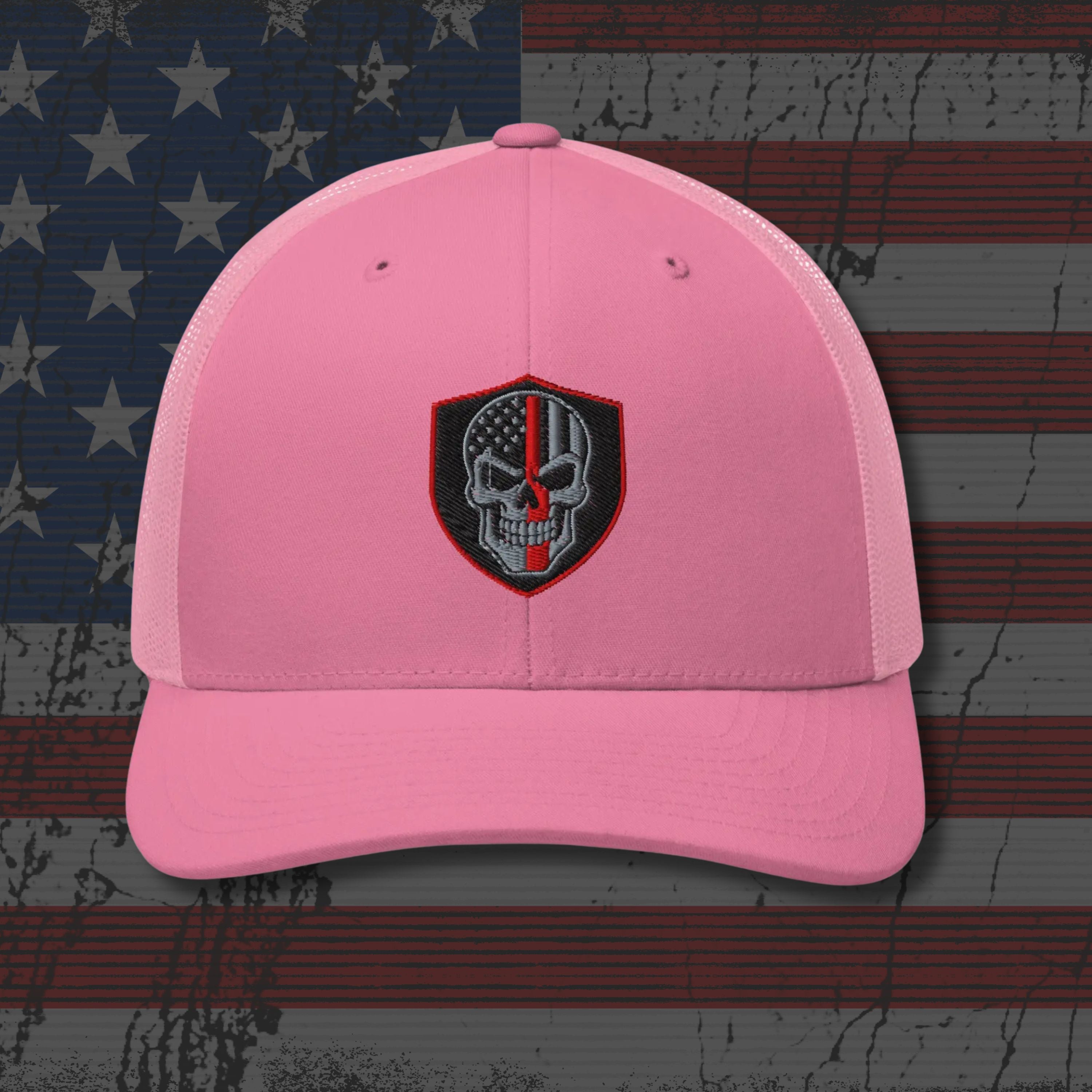 Pink cap with a skull emblem on an American flag background
