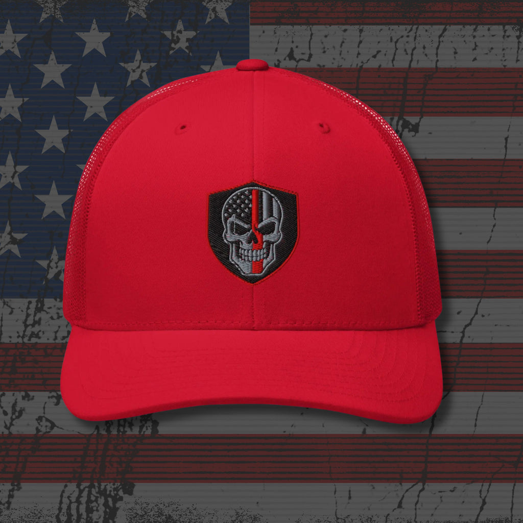 Red cap with a black and white emblem on an American flag background