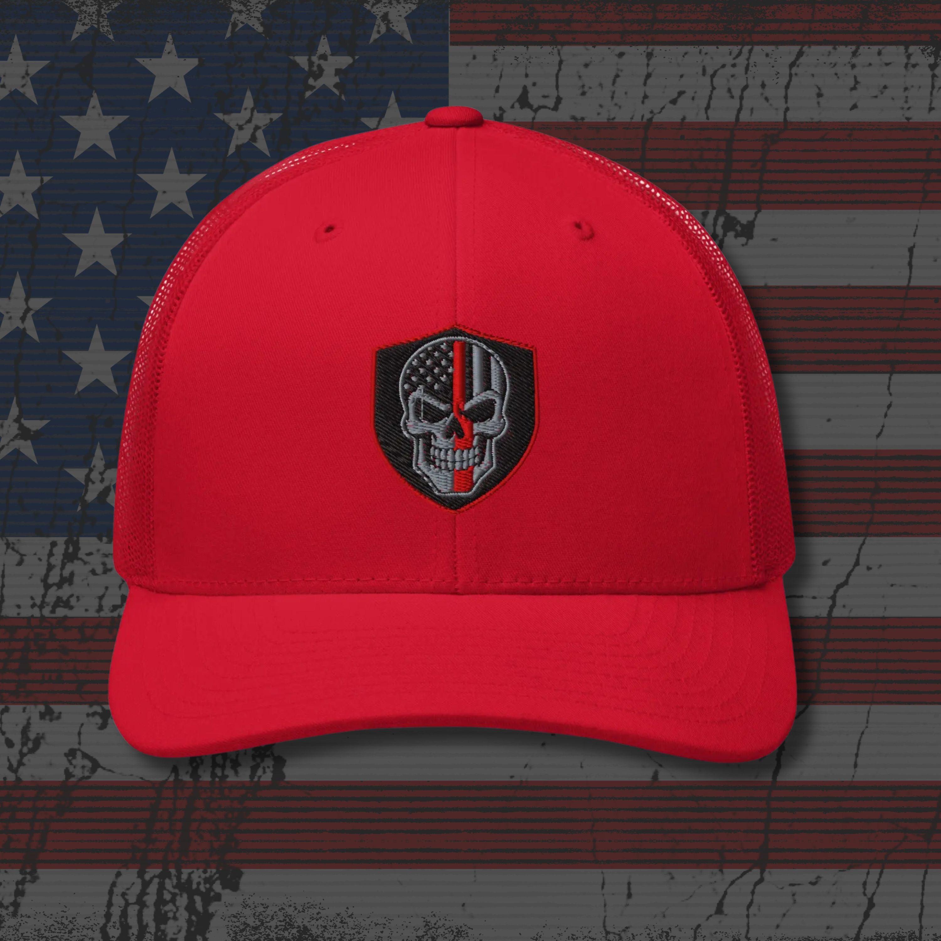Red cap with a black and white emblem on an American flag background