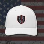 White cap with a skull emblem on an American flag background