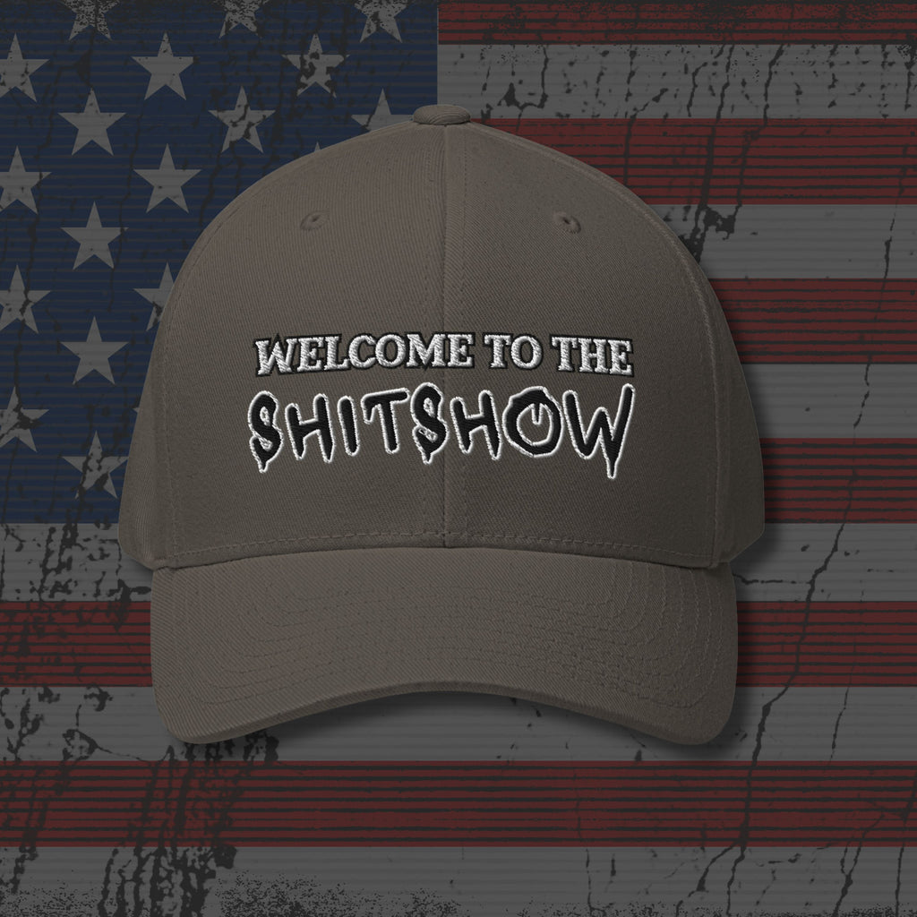 Beige cap with 'WELCOME TO THE SHITSHOW' text on an American flag background