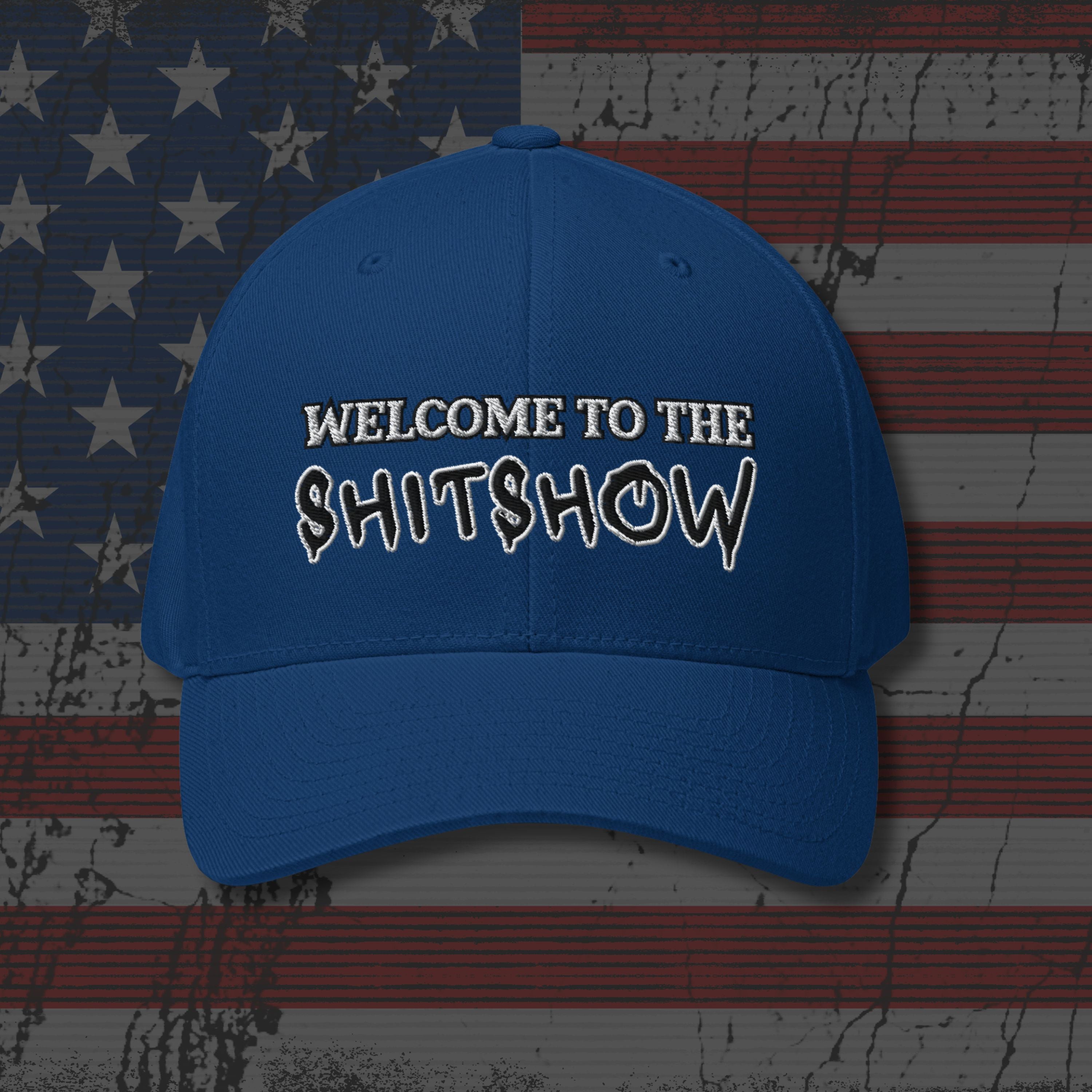 Blue cap with text 'WELCOME TO THE SHITSHOW' on an American flag background
