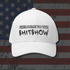White cap with 'Welcome to the Shitshow' text on an American flag background