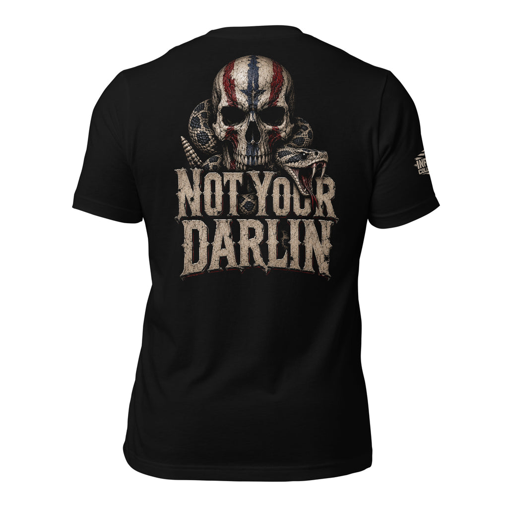 Not Your Darling back print graphic on black tee featuring a distressed skull with American flag markings and a coiled rattlesnake