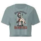 Patriotic pinup woman sitting on the Liberty Bell holding a beer with Star Spangle Hammered text on mineral blue front print tee