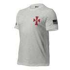 A light heather gray short-sleeve t-shirt with a red Maltese cross on the chest, a black-and-white American flag patch on the right sleeve, and a small black logo on the left sleeve, shown on a plain white background.