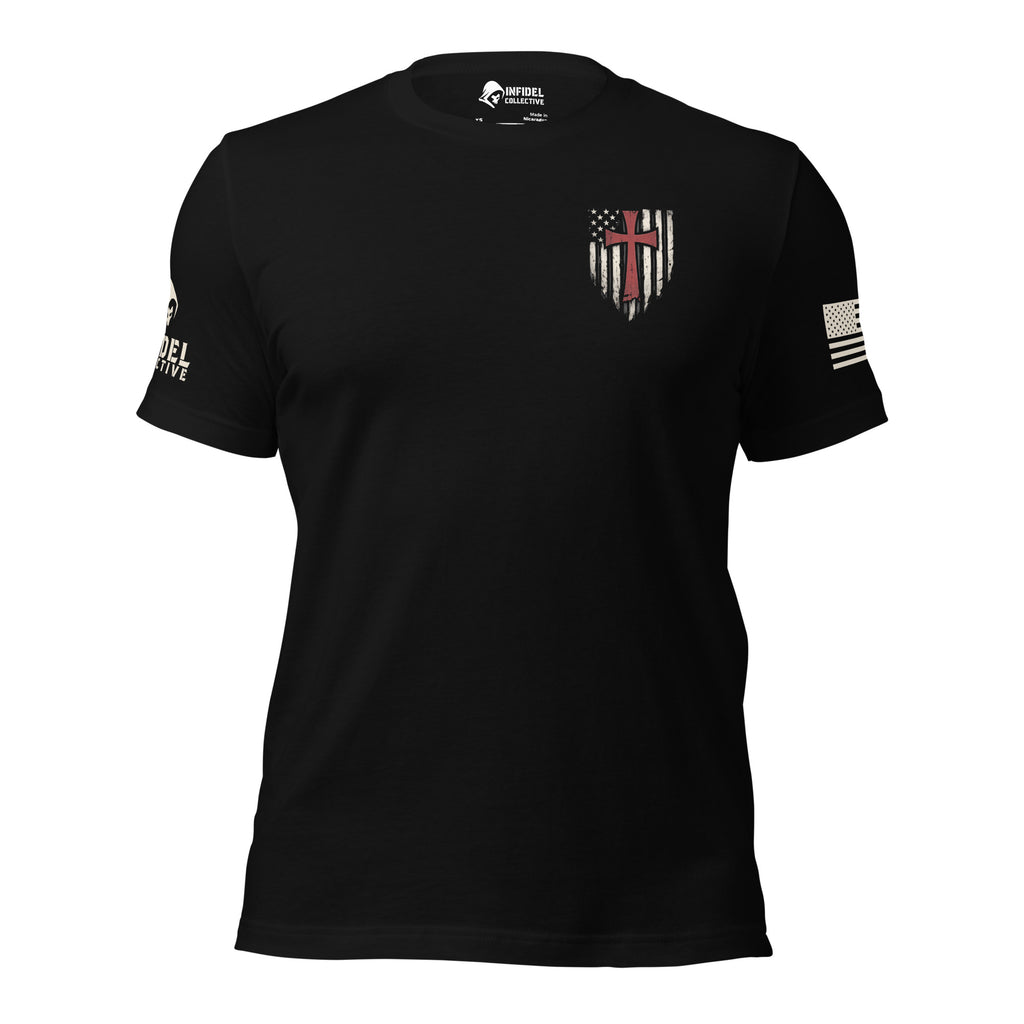 Front view of black tee with small American flag shield and crimson red cross on the left chest. The left sleeve has an American (USA) flag and the right sleeve brand logo for INFIDEL COLLECTIVE.