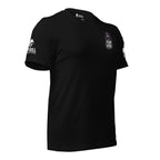 Black t-shirt with a reaper and "FEAR THE INFIDEL' TEXT integrated into the graphic at the front left chest pocket area, and sleeve patch of the brand "INFIDEL COLLECTIVE" on one sleeve and the USA flag on the other, on a white background
